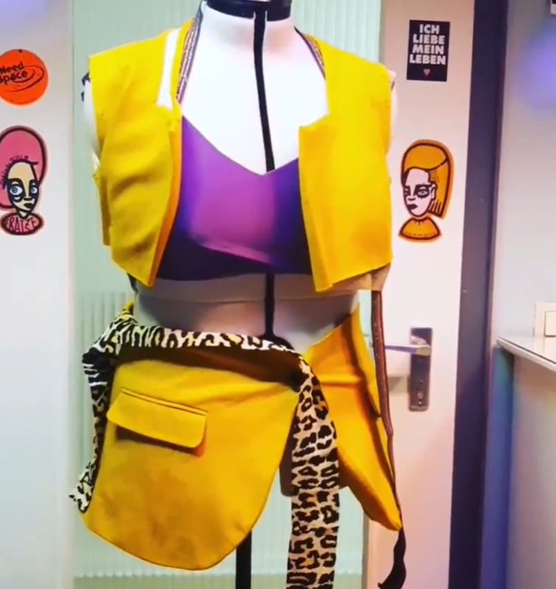 Yellow costume with purple accents and leopard print details